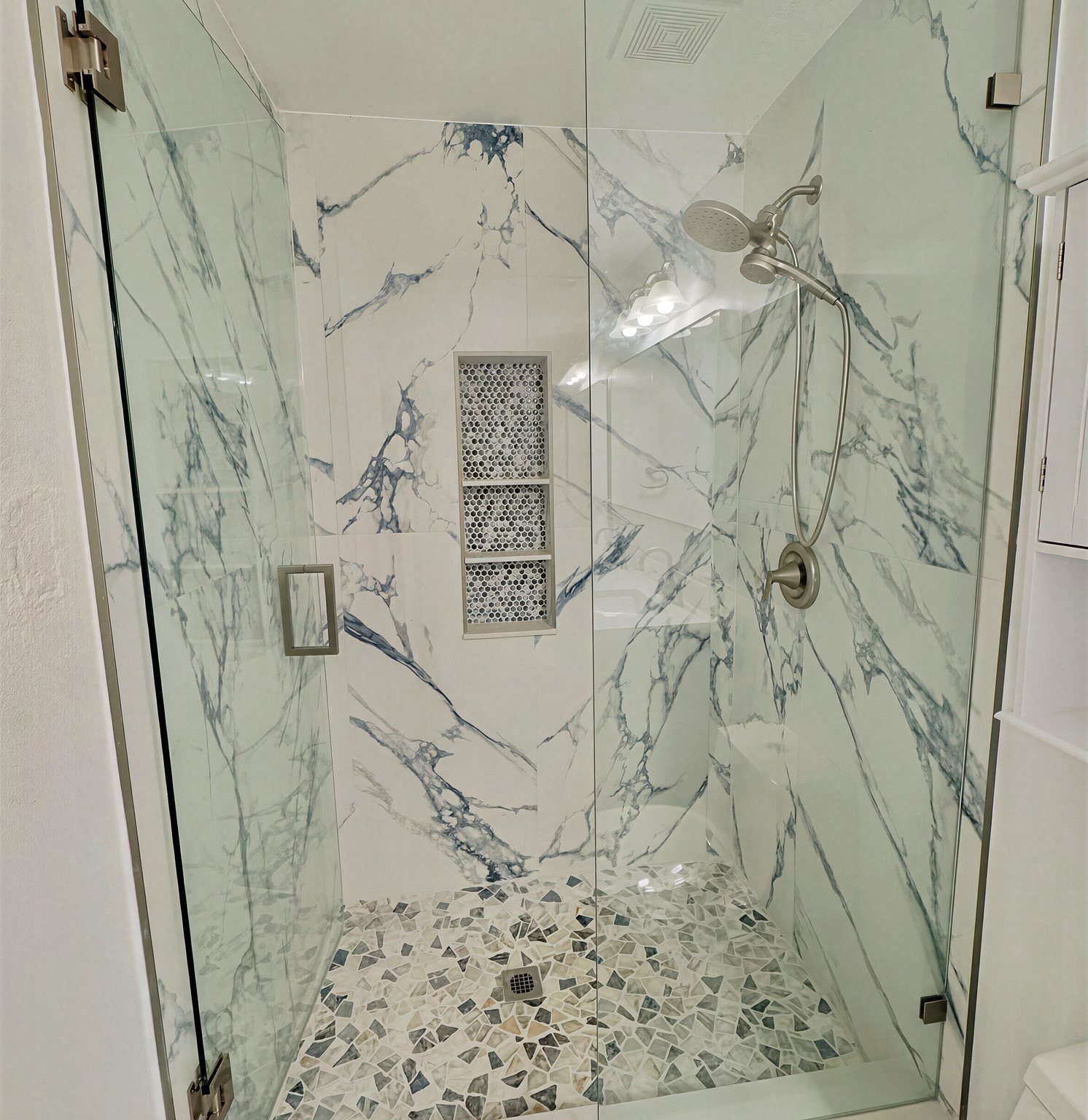 Blue-veined marble master bathroom with gold fixtures
