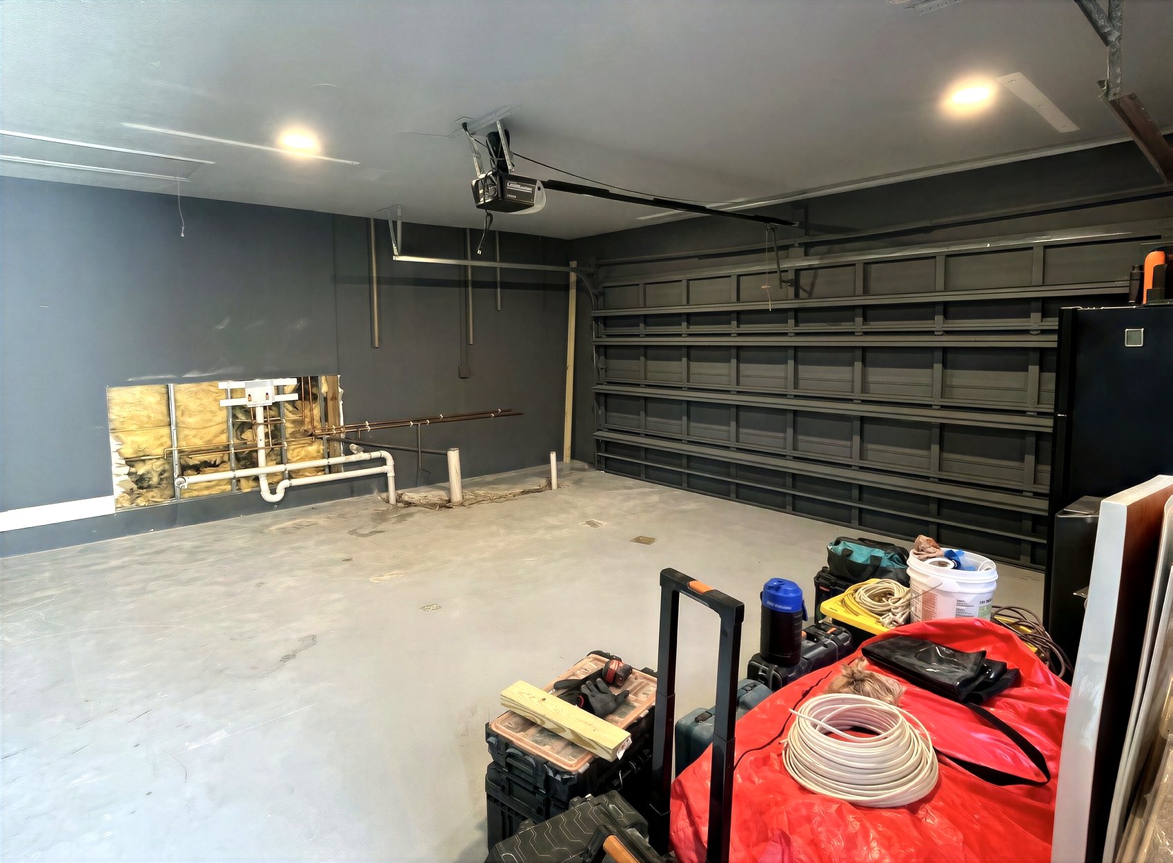 Garage before renovation — bare framing and concrete