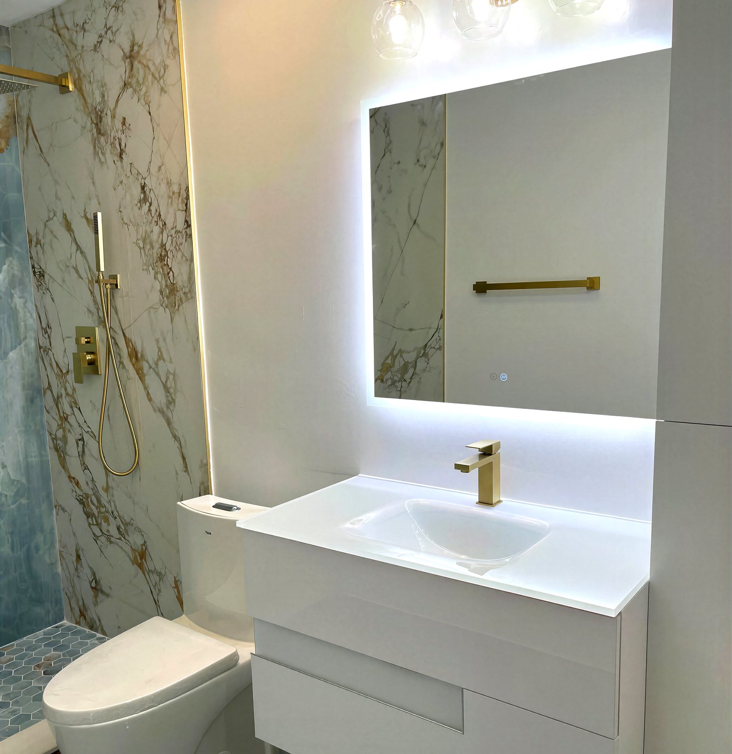 Gold marble bathroom with LED mirror and blue accent shower