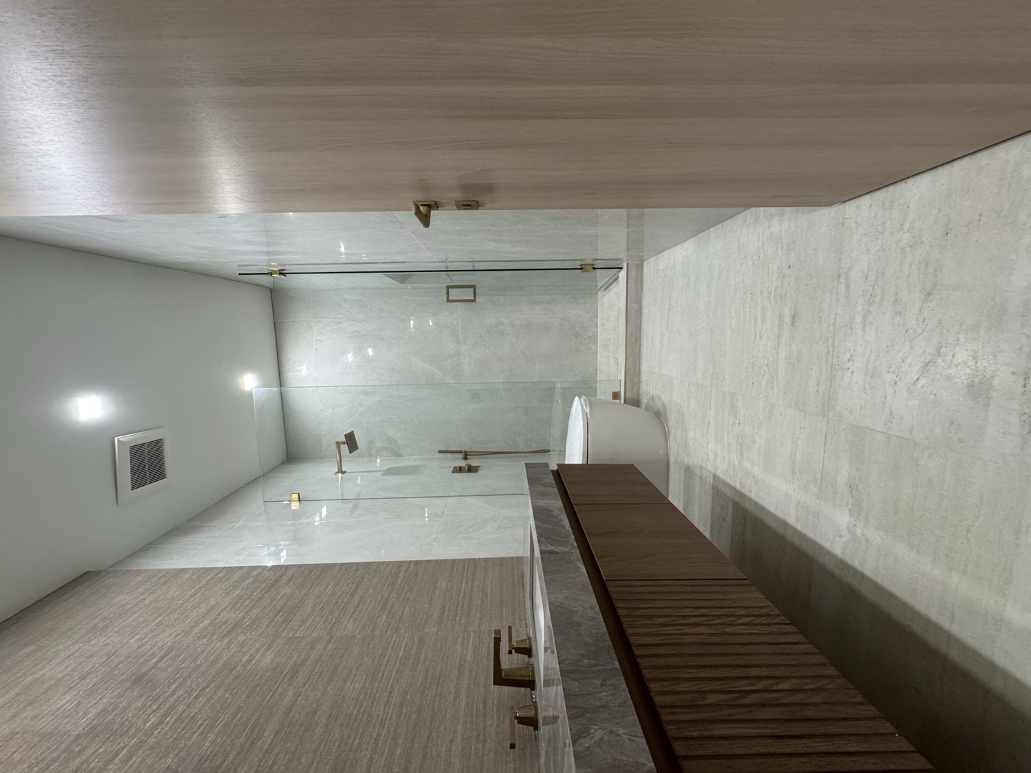 Luxury marble bathroom with wood vanity and gold fixtures