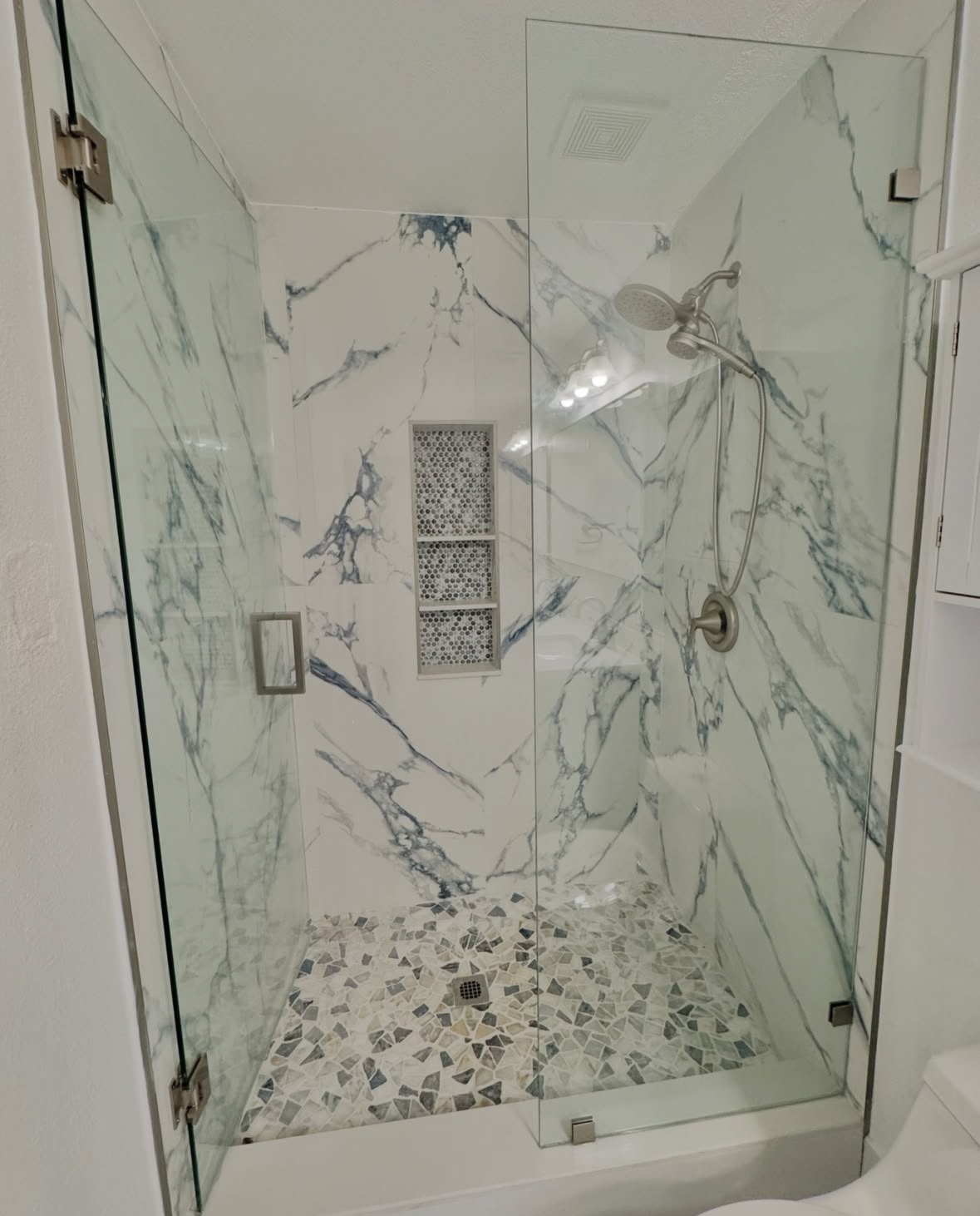 Marble shower with blue stone tile